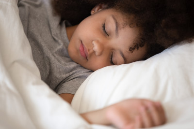 child sleeping in bed