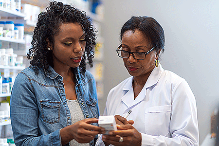 Pharmacist helping woman with hair loss products