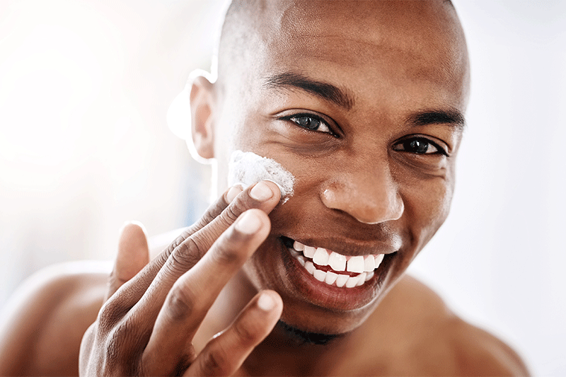 Man applying moisturizer to his face